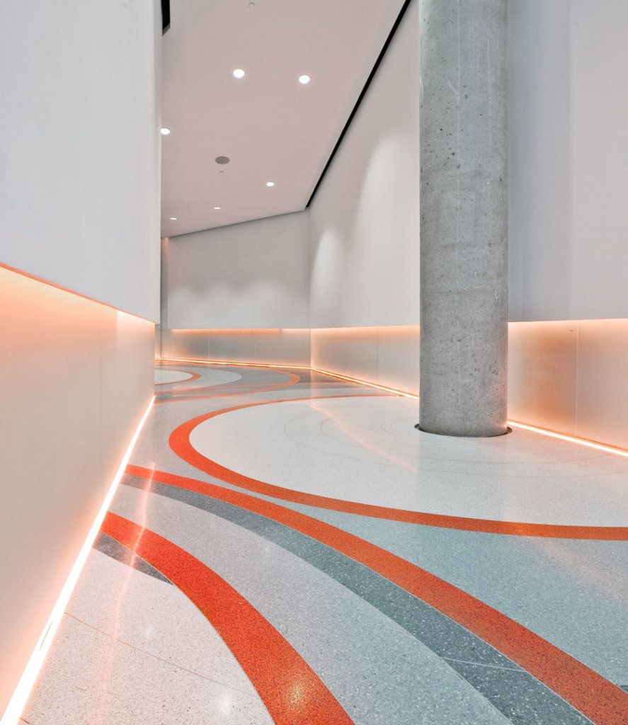 Back-painted decorative glass used across a premium interior wall and floor