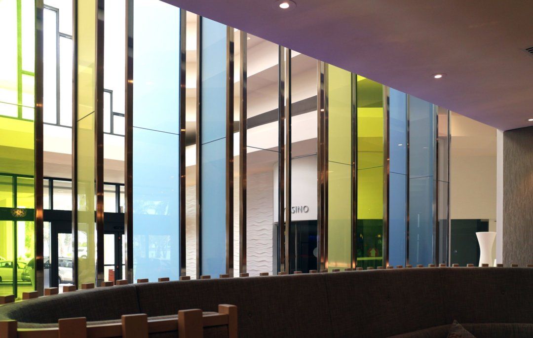 Colored decorative glass feature wall in a high-end commercial interior