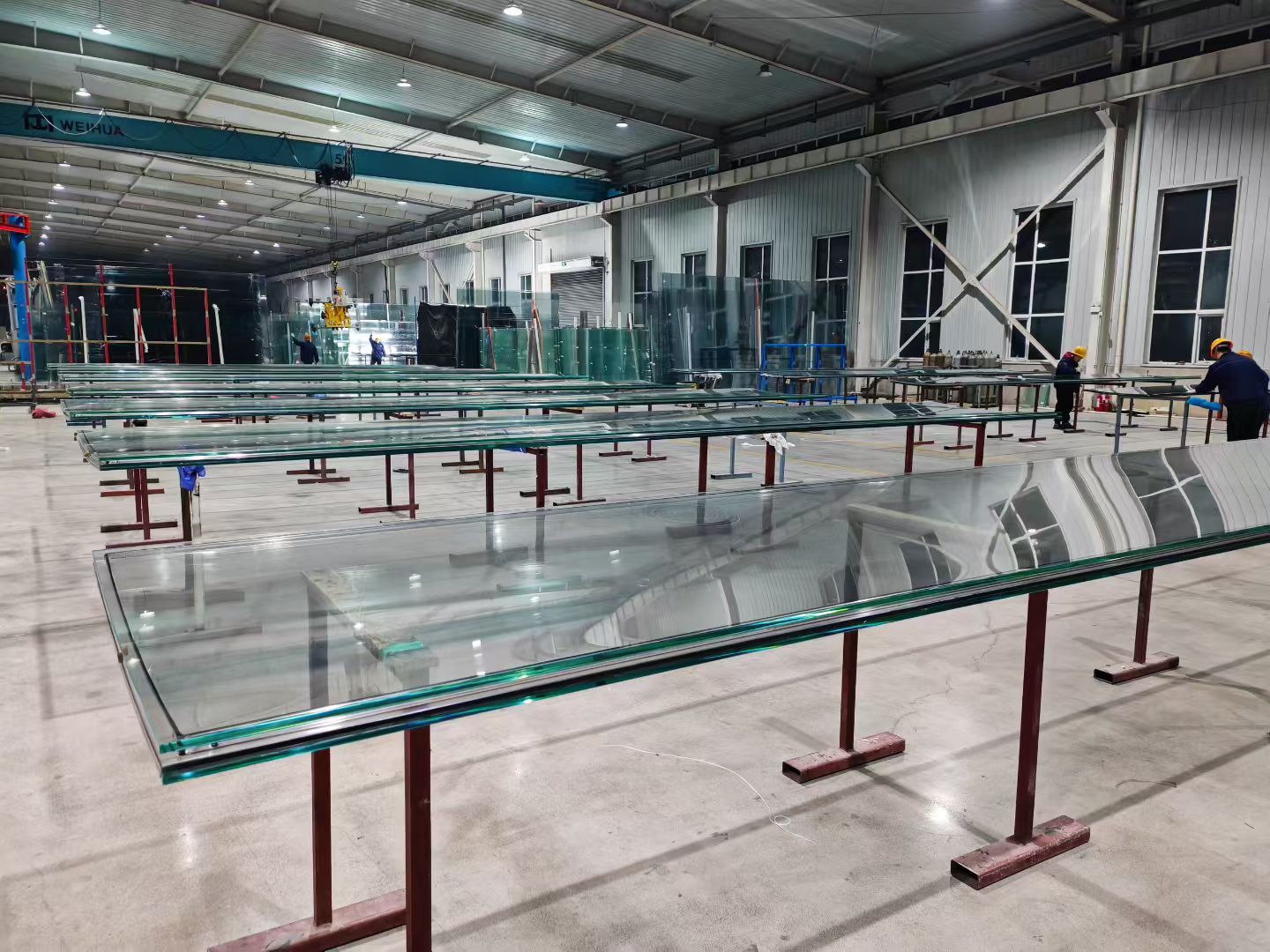 Long curved panels supported across work tables.