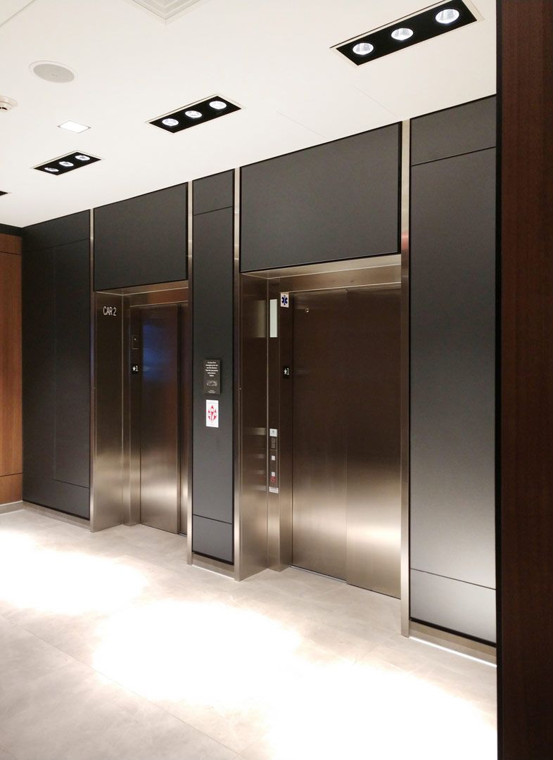 Etched mirror panels surrounding elevators in a hotel lobby