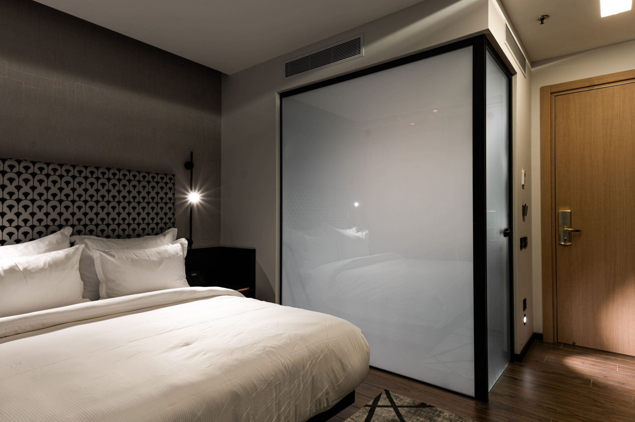 Switchable privacy smart glass enclosing a hotel bathroom