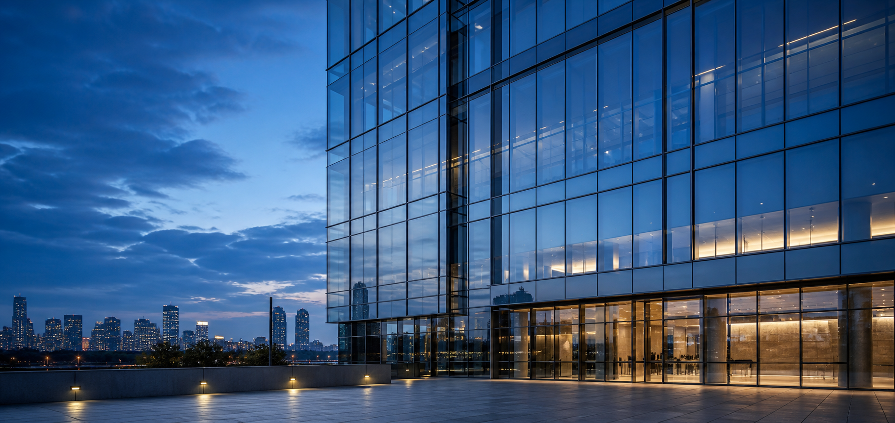 Contemporary high-rise glass curtain wall at blue hour