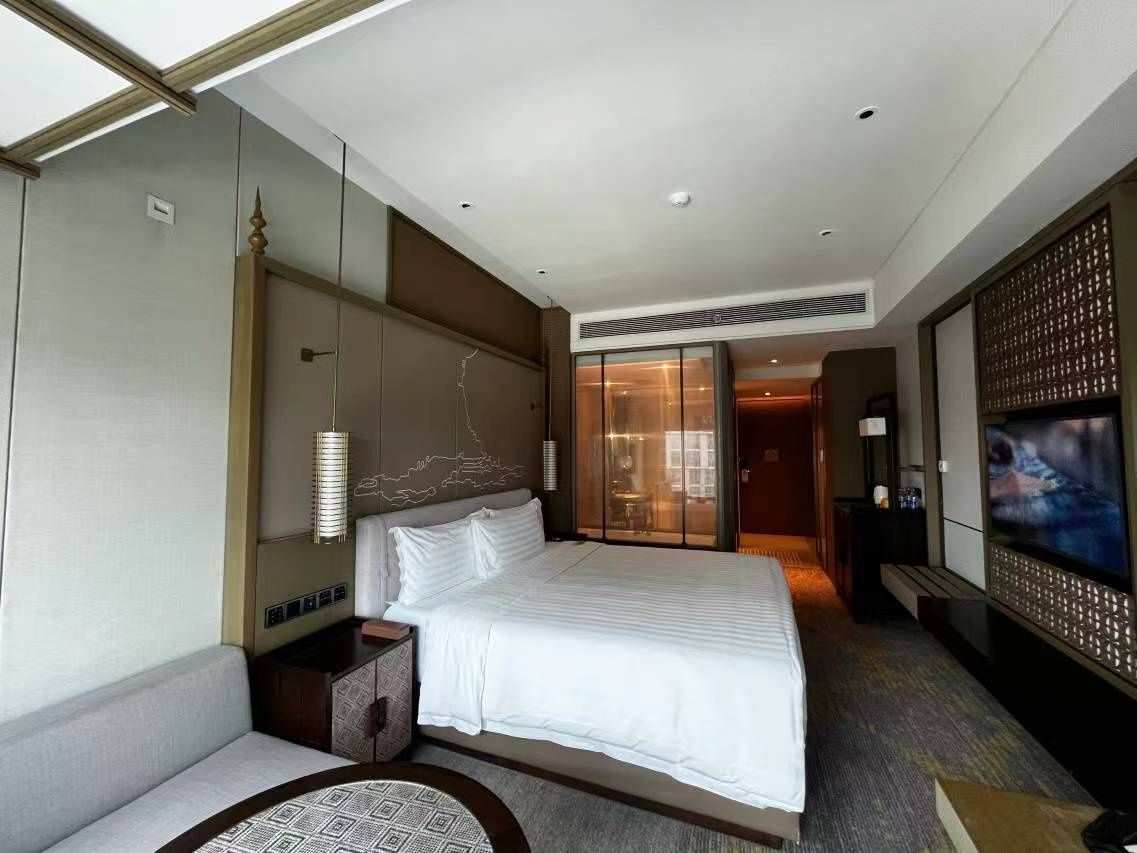 Glass screen incorporated into a hotel guestroom
