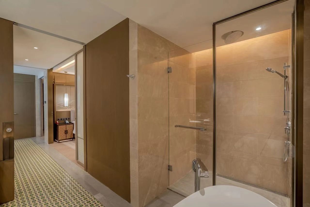 Clear shower glass enclosure in a hotel bathroom