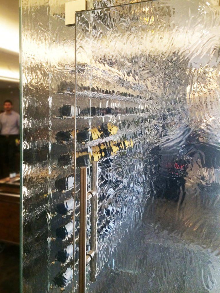 Deeply textured cast glass door in a luxury hospitality setting