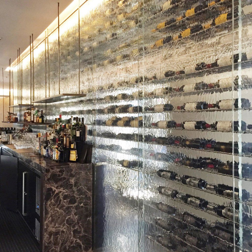 Large thermoformed cast glass wall within a premium restaurant
